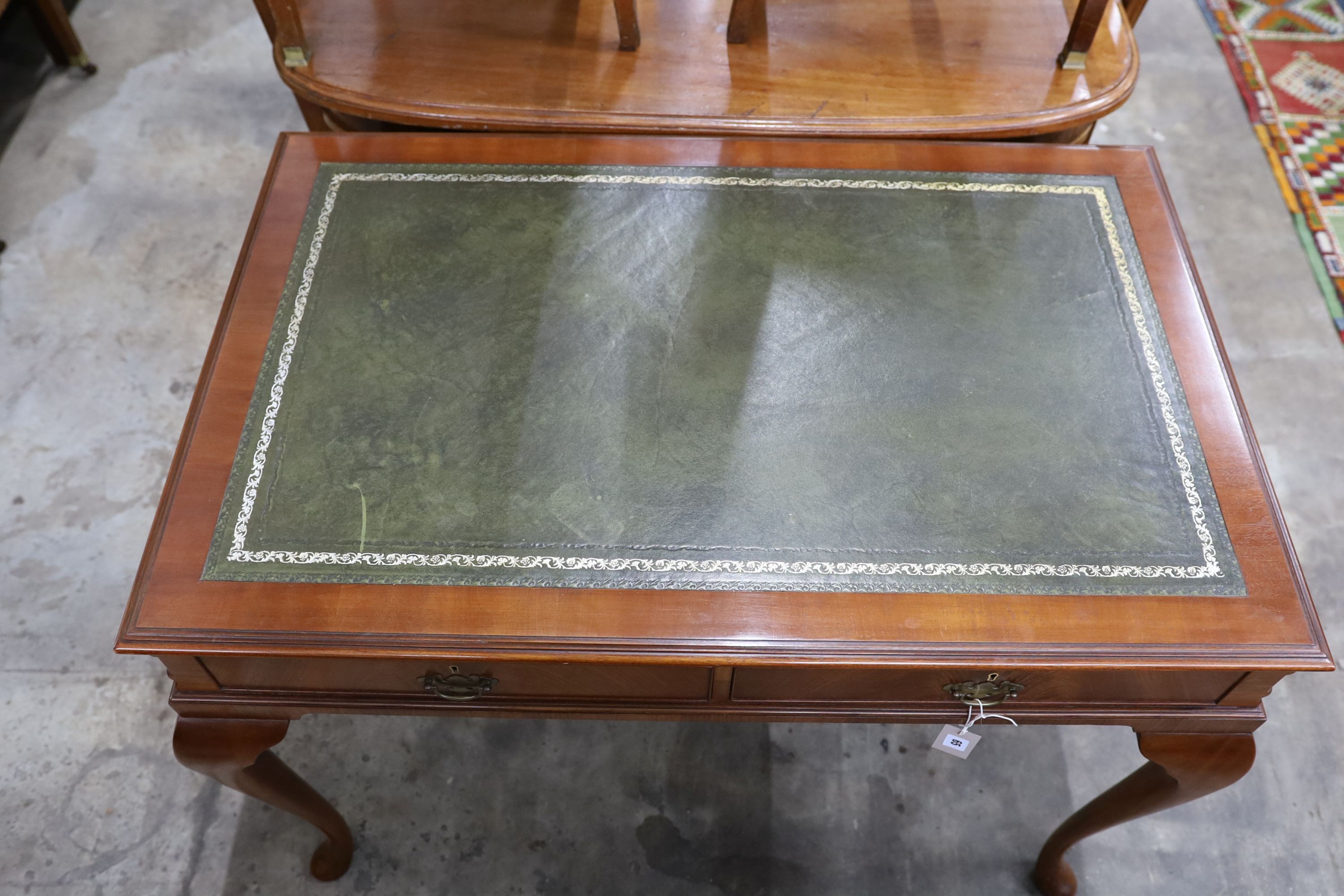 A reproduction George III style mahogany two drawer writing table, width 110cm, depth 72cm, height 77cm